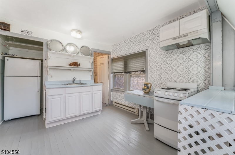 400 Church Street, Unit A Hackettstown, NJ 07840 - Photo 8 of 19 a kitchen with stainless steel appliances kitchen island granite countertop a refrigerator and a stove top oven