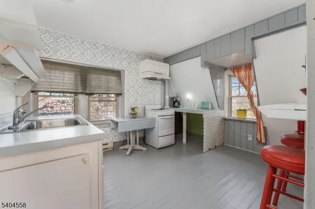 a kitchen with a refrigerator and white cabinets