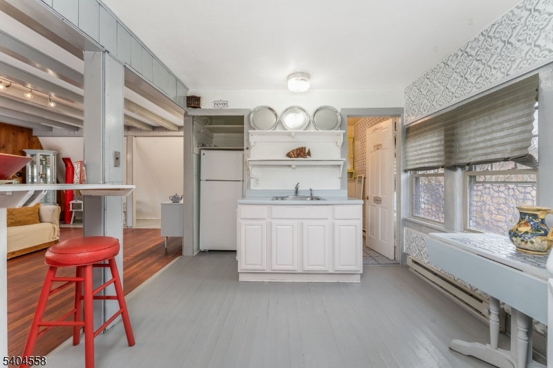 400 Church Street, Unit A Hackettstown, NJ 07840 - Photo 10 of 19 a kitchen with a refrigerator and white cabinets