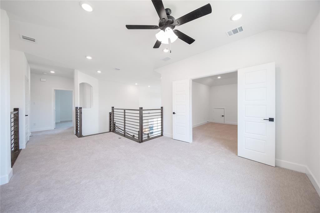 2719 Triumph Court Heath, TX 75126 - Photo 16 of 39 an empty room with ceiling fan and windows