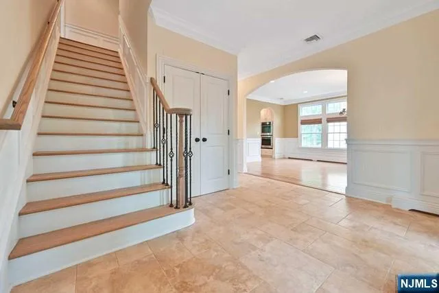 a view of a livingroom with wooden floor and stairs