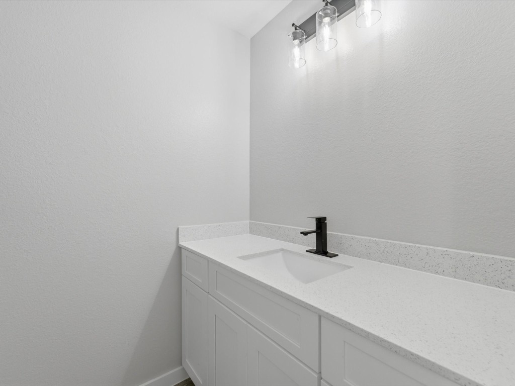 413 South 12th Street Conroe, TX 77301 - Photo 13 of 22 a bathroom with a sink and mirror