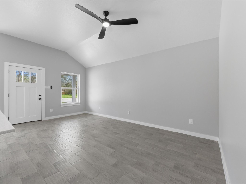 413 South 12th Street Conroe, TX 77301 - Photo 3 of 22 an empty room with windows and ceiling fan