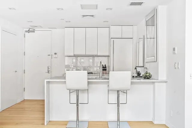 a kitchen with stainless steel appliances granite countertop a sink and stove