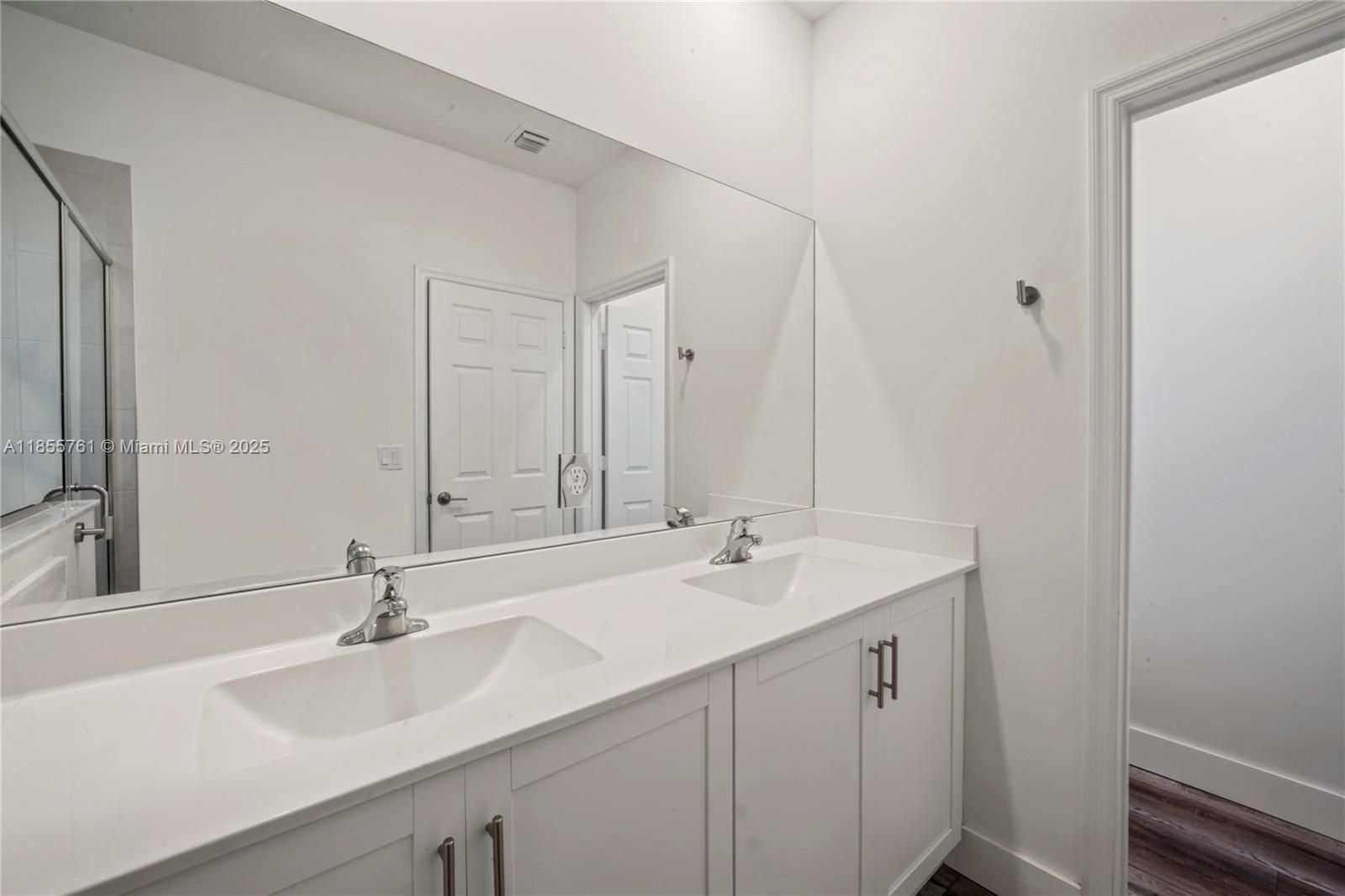 3471 West 110th Street Hialeah, FL 33018 - Photo 14 of 38 a bathroom with a sink and a mirror