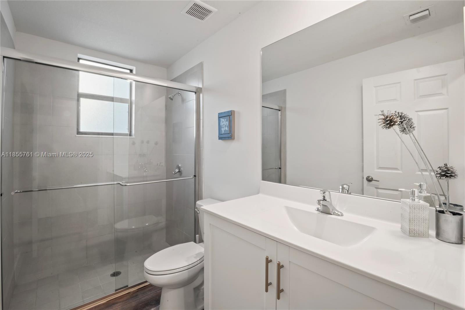 3471 West 110th Street Hialeah, FL 33018 - Photo 16 of 38 a bathroom with a sink toilet and shower