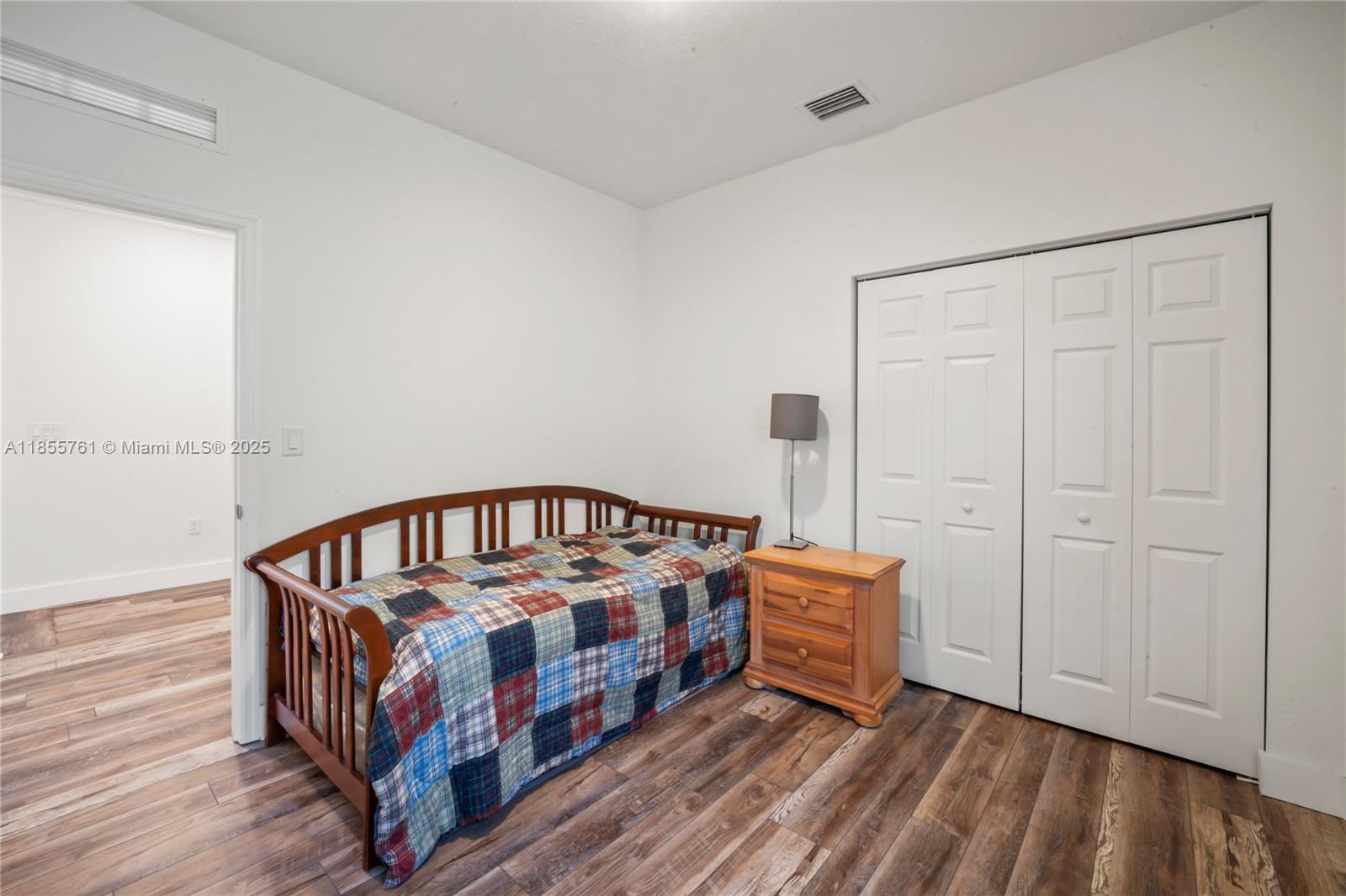 3471 West 110th Street Hialeah, FL 33018 - Photo 27 of 38 a bedroom with a bed and a book shelf