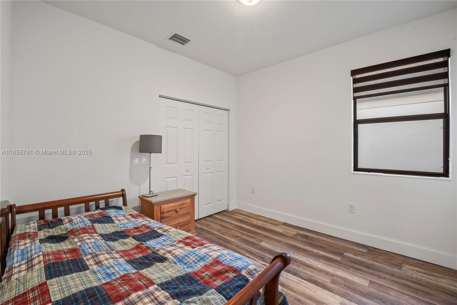 3471 West 110th Street Hialeah, FL 33018 - Photo 28 of 38 a bed sitting in a bedroom next to a window