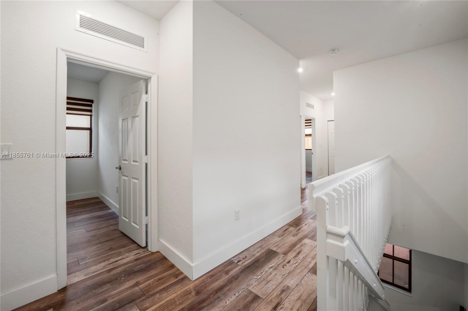 3471 West 110th Street Hialeah, FL 33018 - Photo 29 of 38 a view of a hallway with wooden floor and stairs