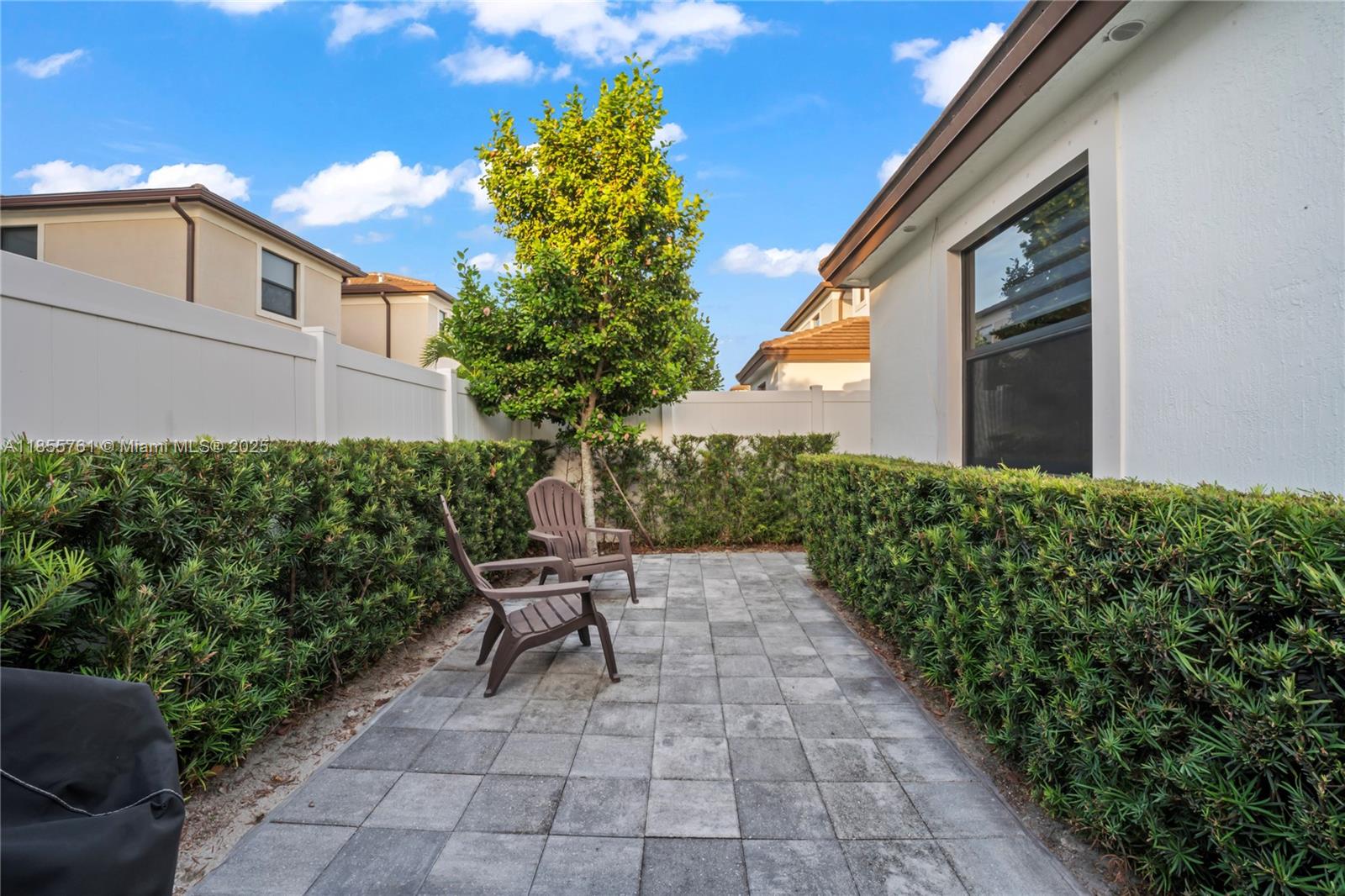 3471 West 110th Street Hialeah, FL 33018 - Photo 35 of 38 a backyard of a house with table and chairs