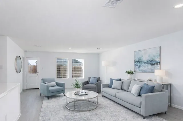 a living room with furniture and a large window