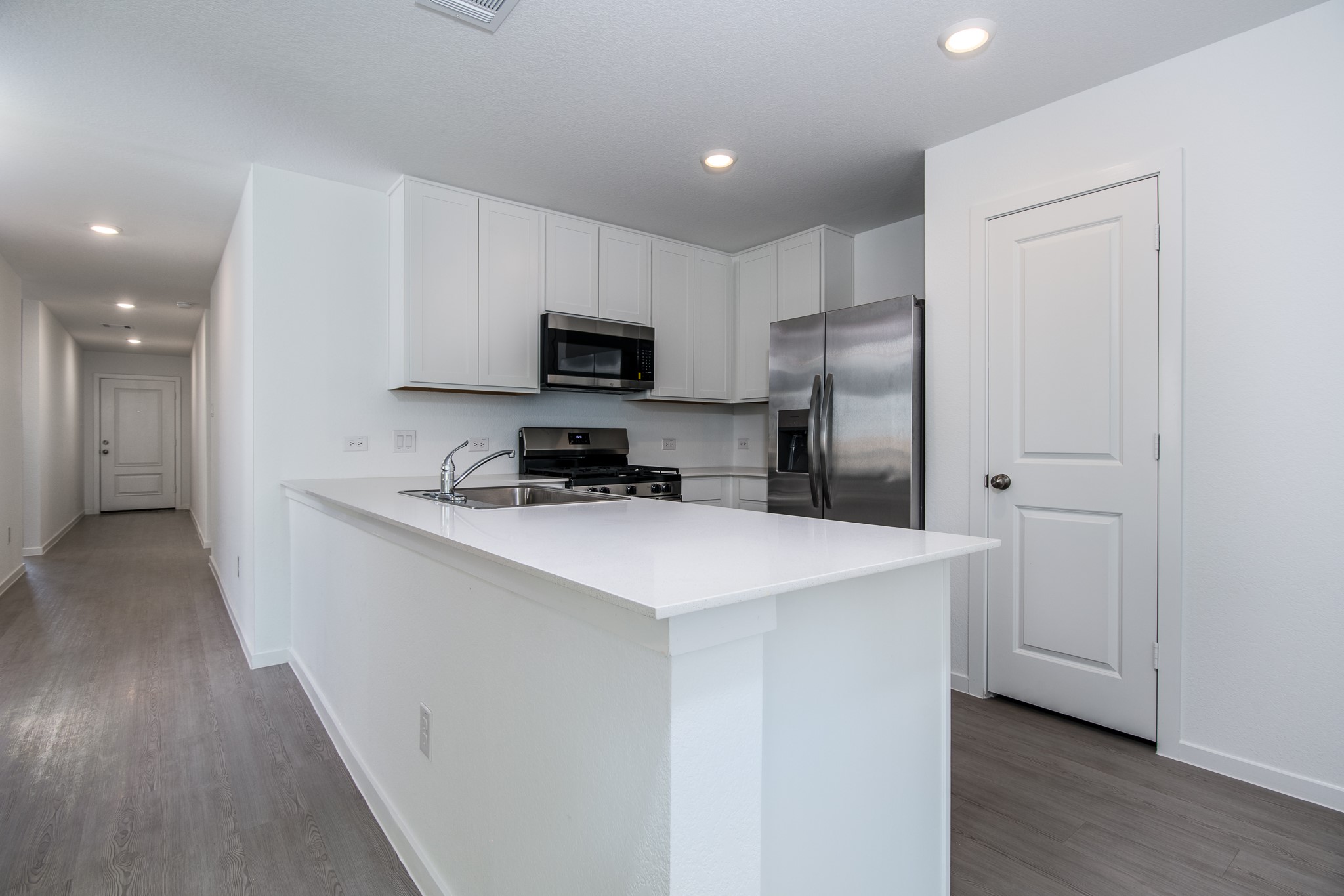 3013 Colusa Rdg Drive Katy, TX 77493 - Photo 5 of 15 a kitchen with kitchen island a refrigerator sink and cabinets