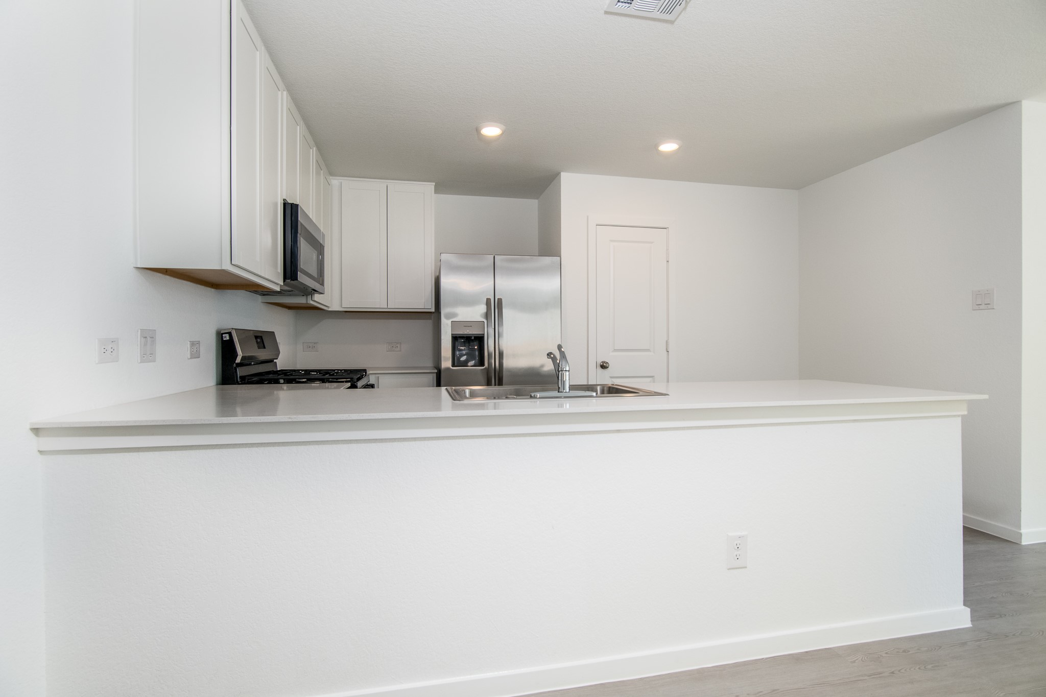 3013 Colusa Rdg Drive Katy, TX 77493 - Photo 6 of 15 a kitchen with stainless steel appliances granite countertop a sink a stove and a refrigerator with wooden floor