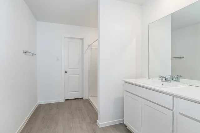 a bathroom with a sink a light fixture and a mirror