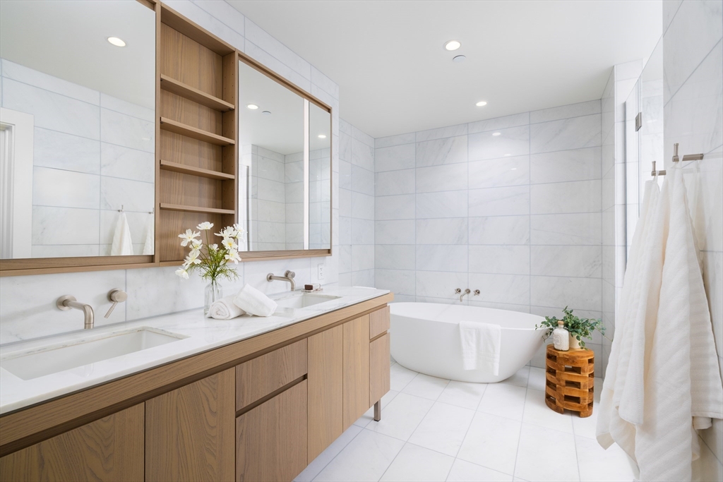 40 Trinity Place, Unit 23C Boston, MA 02116 - Photo 11 of 41 a bathroom with a double vanity sink mirror and bathtub