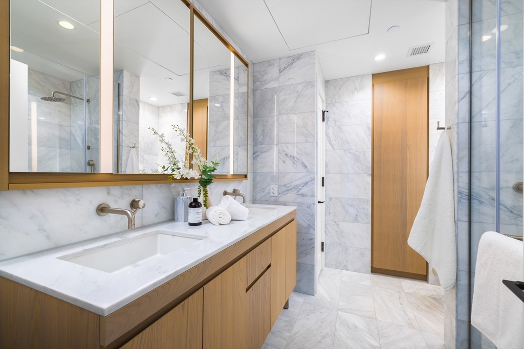 40 Trinity Place, Unit 23C Boston, MA 02116 - Photo 16 of 41 a bathroom with a tub sink and mirror