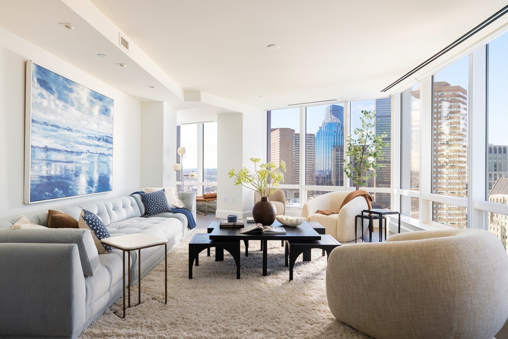 40 Trinity Place, Unit 23C Boston, MA 02116 - Photo 2 of 41 a living room with furniture and floor to ceiling windows