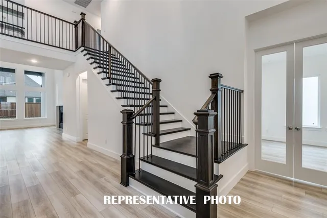 a view of entryway and hall with wooden floor
