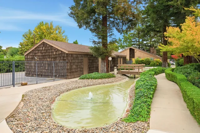 a view of backyard with swimming pool
