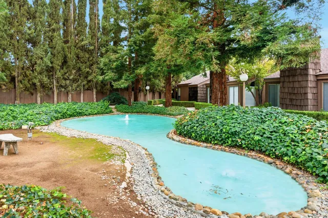 a swimming pool with an outdoor seating and yard