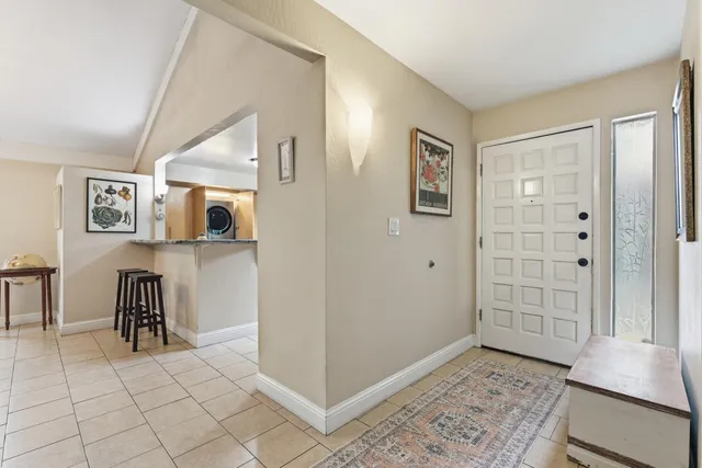 a dining room with furniture a chandelier and a rug