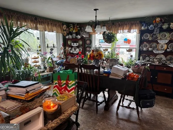 an outdoor dining space with lots of potted plants
