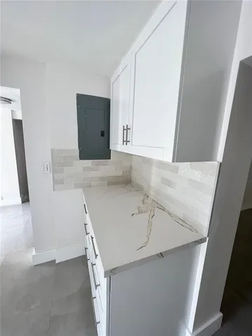 a view of a kitchen with a sink cabinets and a wooden floor