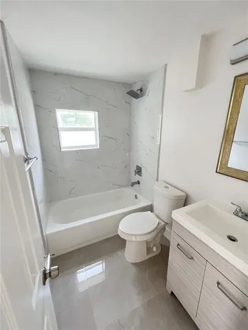 an aerial view of a house with a garden and lake view