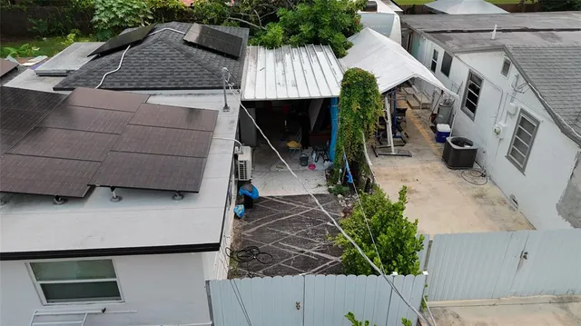 an aerial view of a house with yard swimming pool and outdoor seating