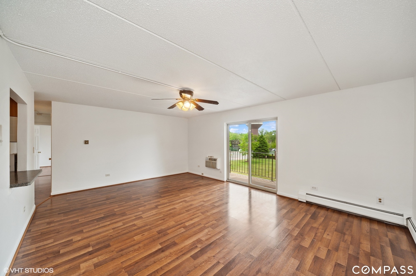 575 Fairway View Drive, Unit 2F Wheeling, IL 60090 - Photo 2 of 14 wooden floor in an empty room with a window