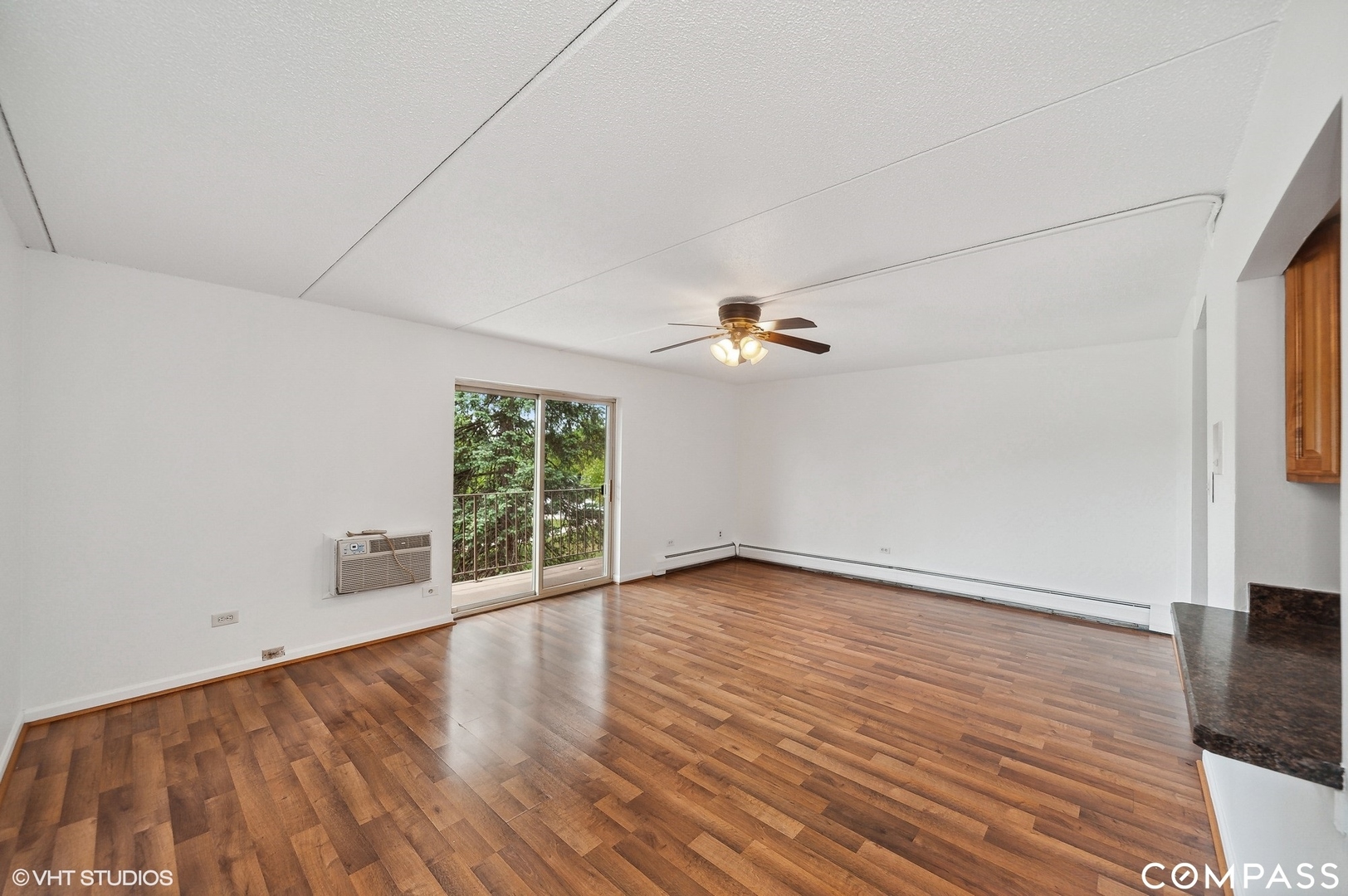 575 Fairway View Drive, Unit 2F Wheeling, IL 60090 - Photo 4 of 14 wooden floor in an empty room with a window