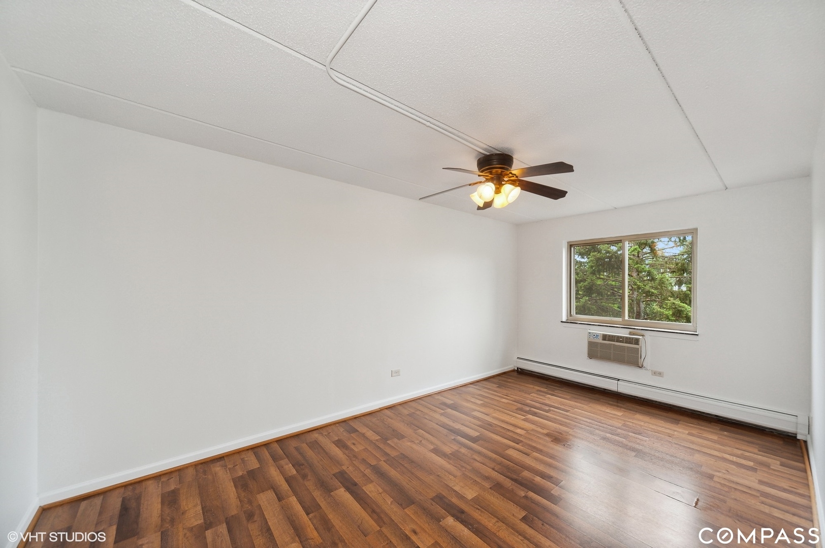 575 Fairway View Drive, Unit 2F Wheeling, IL 60090 - Photo 8 of 14 a view of empty room with wooden floor and fan
