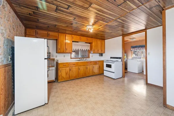 a kitchen with stainless steel appliances granite countertop a refrigerator and a stove