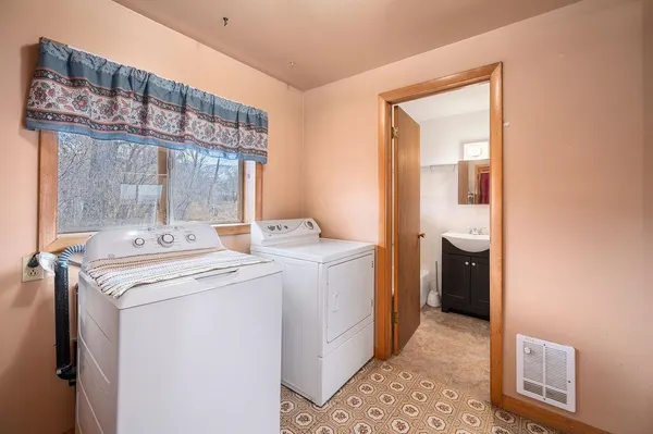 a bathroom with a toilet a sink and mirror