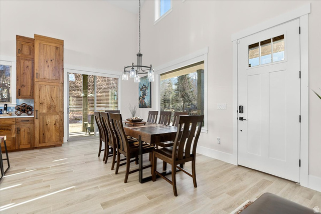 1210 East Bristle Cone Road Pine Valley, UT 84781 - Photo 10 of 54 Dining space with light wood-like tile flooring, a high ceiling, and a chandelier