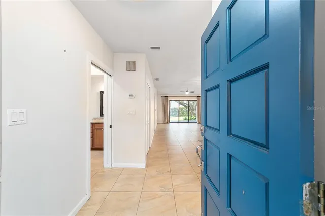 a view of hallway with seating and a window