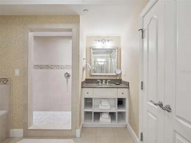 a bathroom with a light fixture a mirror and a sink