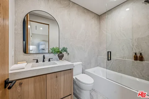 a view of a house with backyard sitting area and furniture