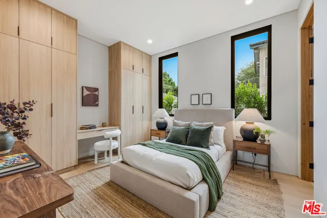 a bathroom with a toilet a sink a mirror and a shower