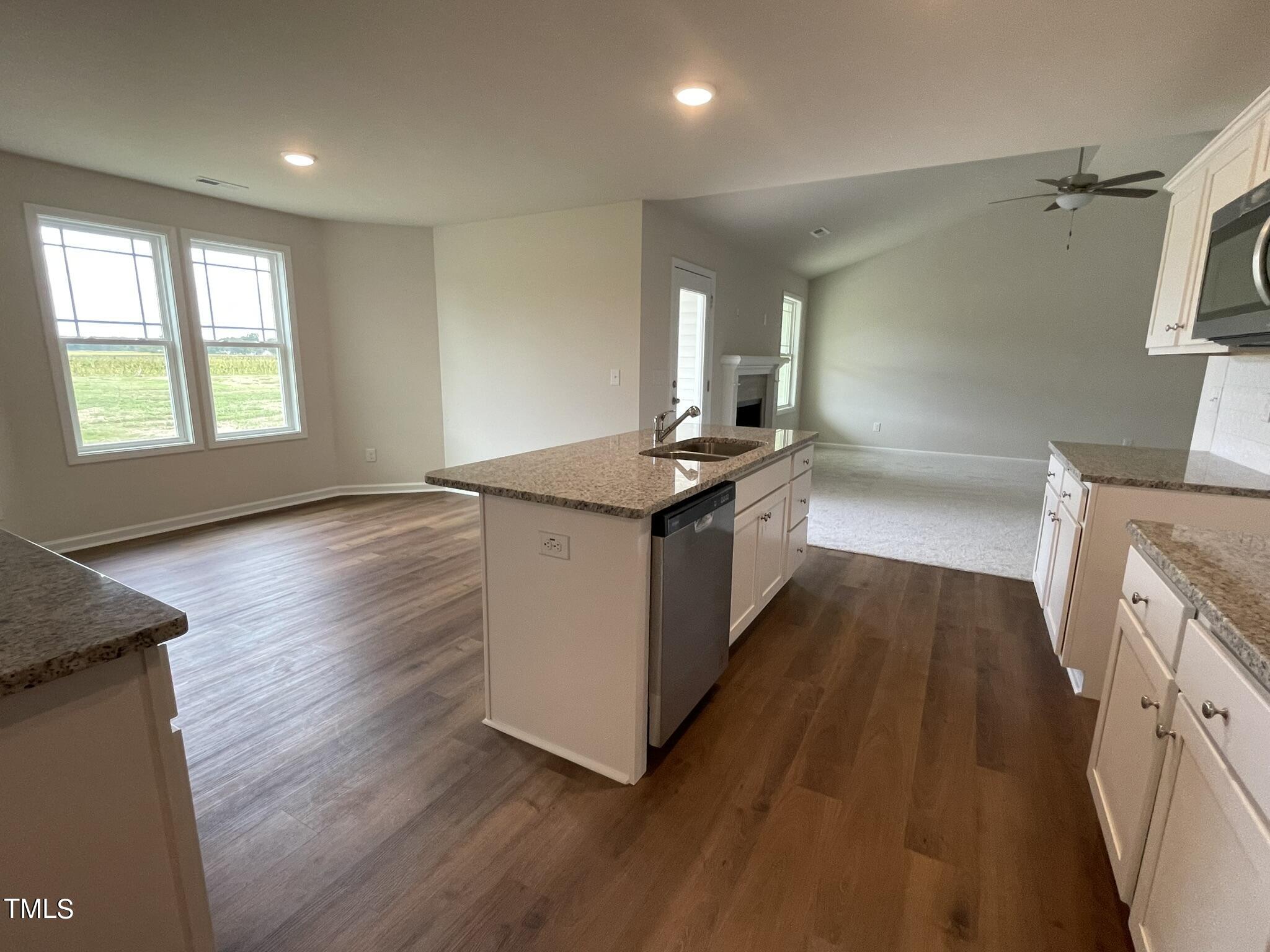 170 Grace Ridge Benson, NC 27504 - Photo 8 of 18 a kitchen with stainless steel appliances granite countertop a stove and a wooden floors