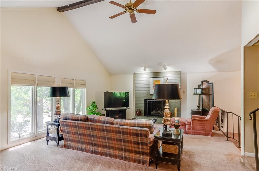 3105 Rolling Road High Point, NC 27265 - Photo 5 of 30 To the left of the foyer is the living room. Vaulted ceilings and tall windows give this space an airy feeling.