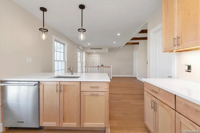 a kitchen with kitchen island a sink stainless steel appliances and cabinets