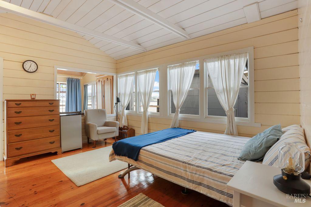 34 Sandy Beach Road Vallejo, CA 94590 - Photo 48 of 63 a bedroom with a bed and wooden floor