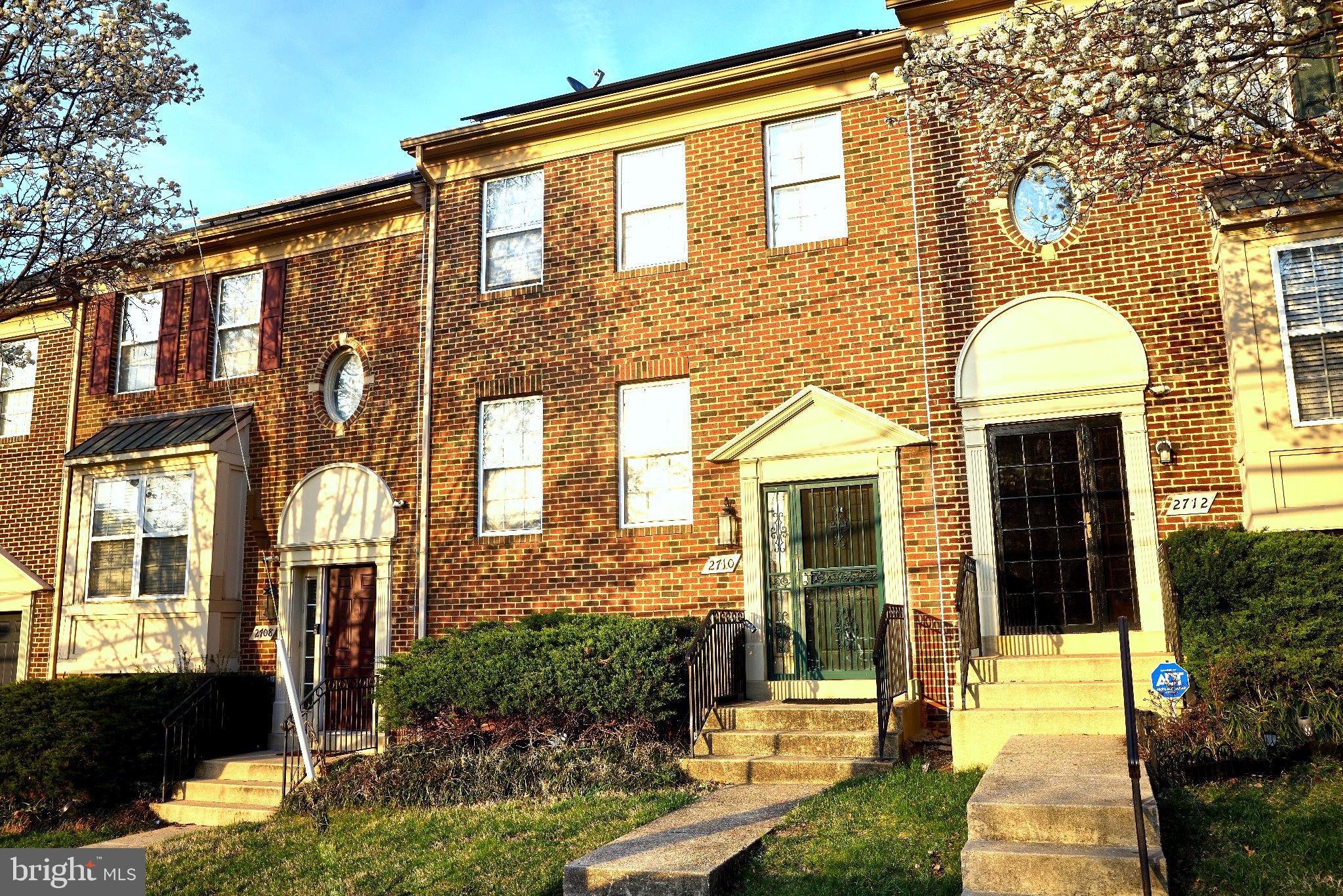 Charming brick townhomes in sunlight.