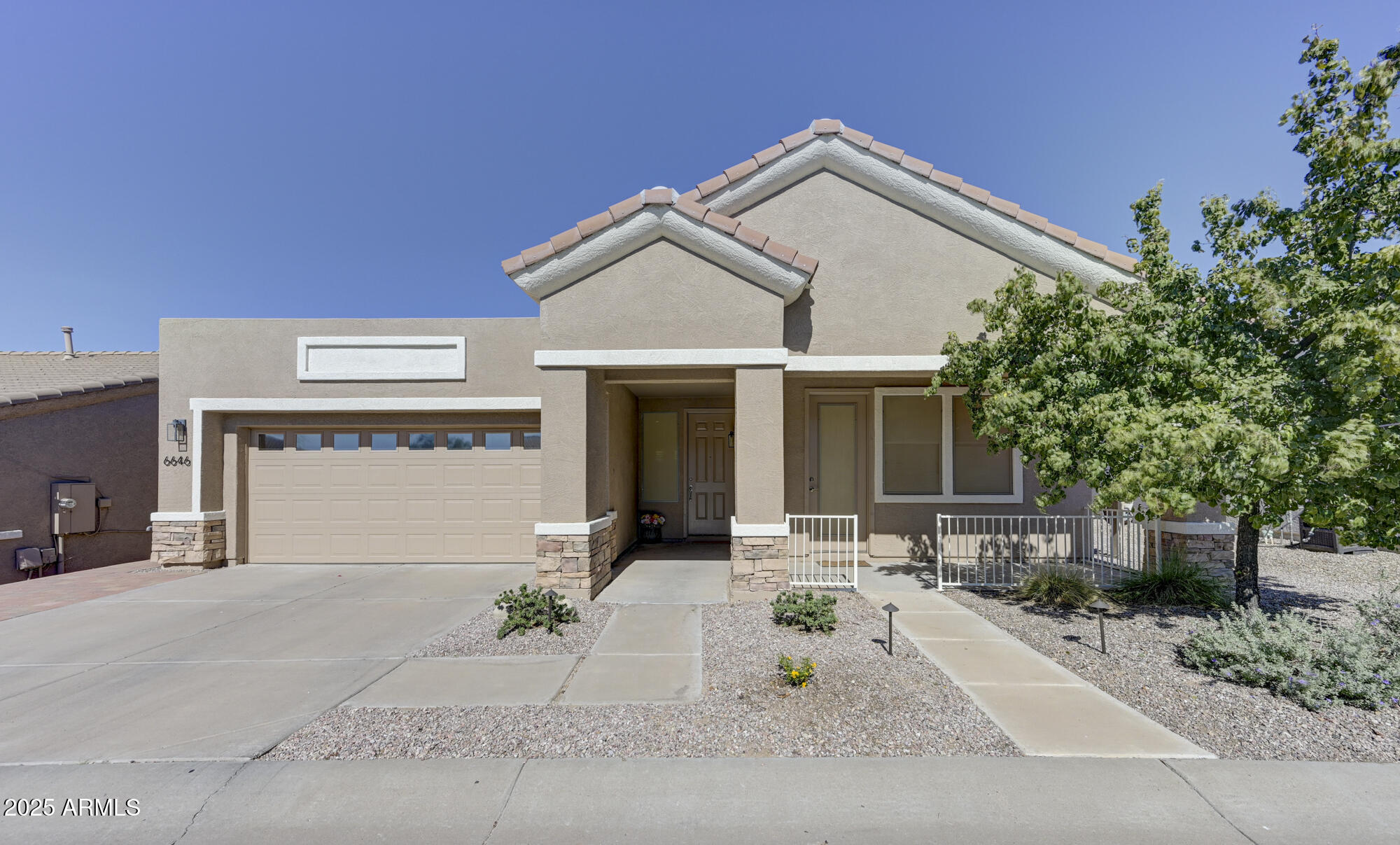 6646 East Rochelle Circle Mesa, AZ 85215 - Photo 1 of 43 a front view of a house with a garden and porch