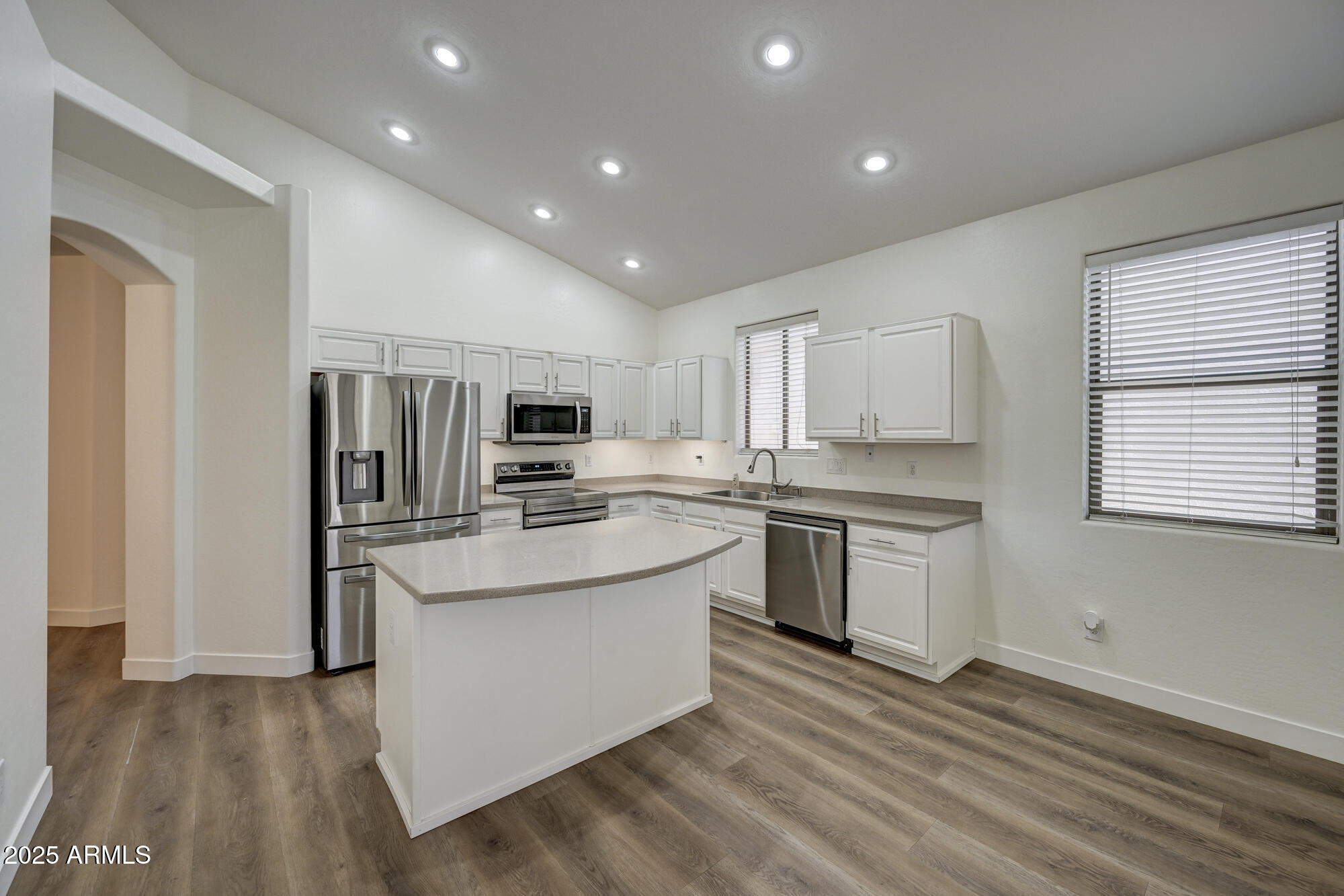 6646 East Rochelle Circle Mesa, AZ 85215 - Photo 14 of 43 a kitchen with kitchen island stainless steel appliances a sink stove and refrigerator