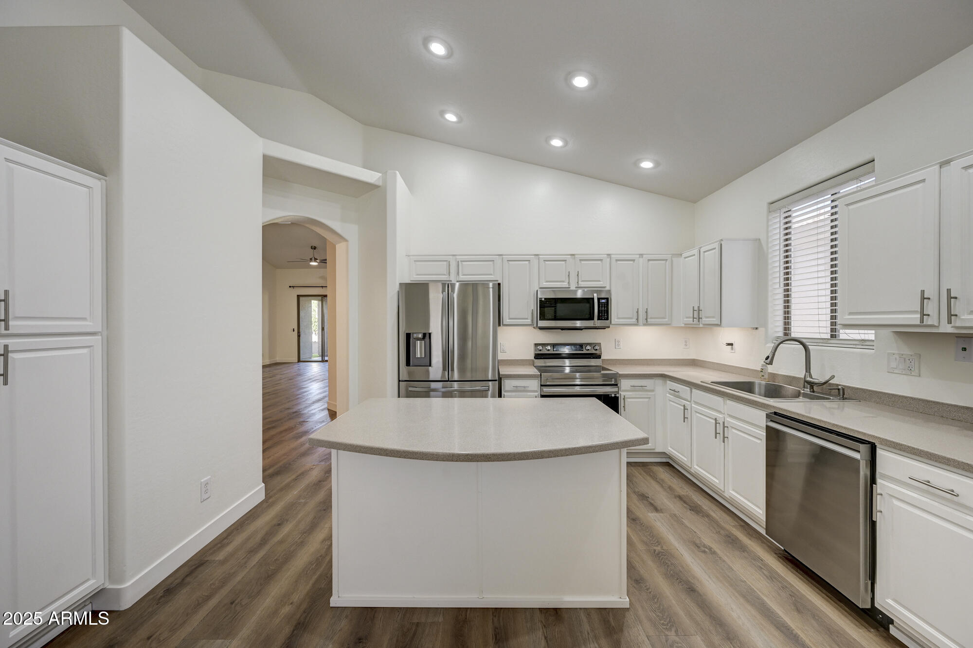 6646 East Rochelle Circle Mesa, AZ 85215 - Photo 15 of 43 a large white kitchen with stainless steel appliances granite countertop a stove and a sink