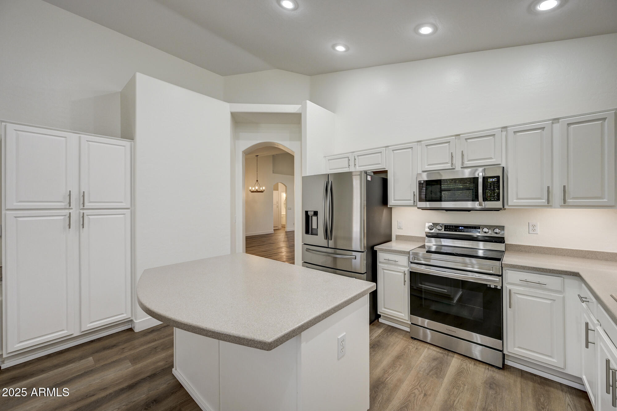 6646 East Rochelle Circle Mesa, AZ 85215 - Photo 17 of 43 a kitchen with stainless steel appliances a stove a microwave and white cabinets