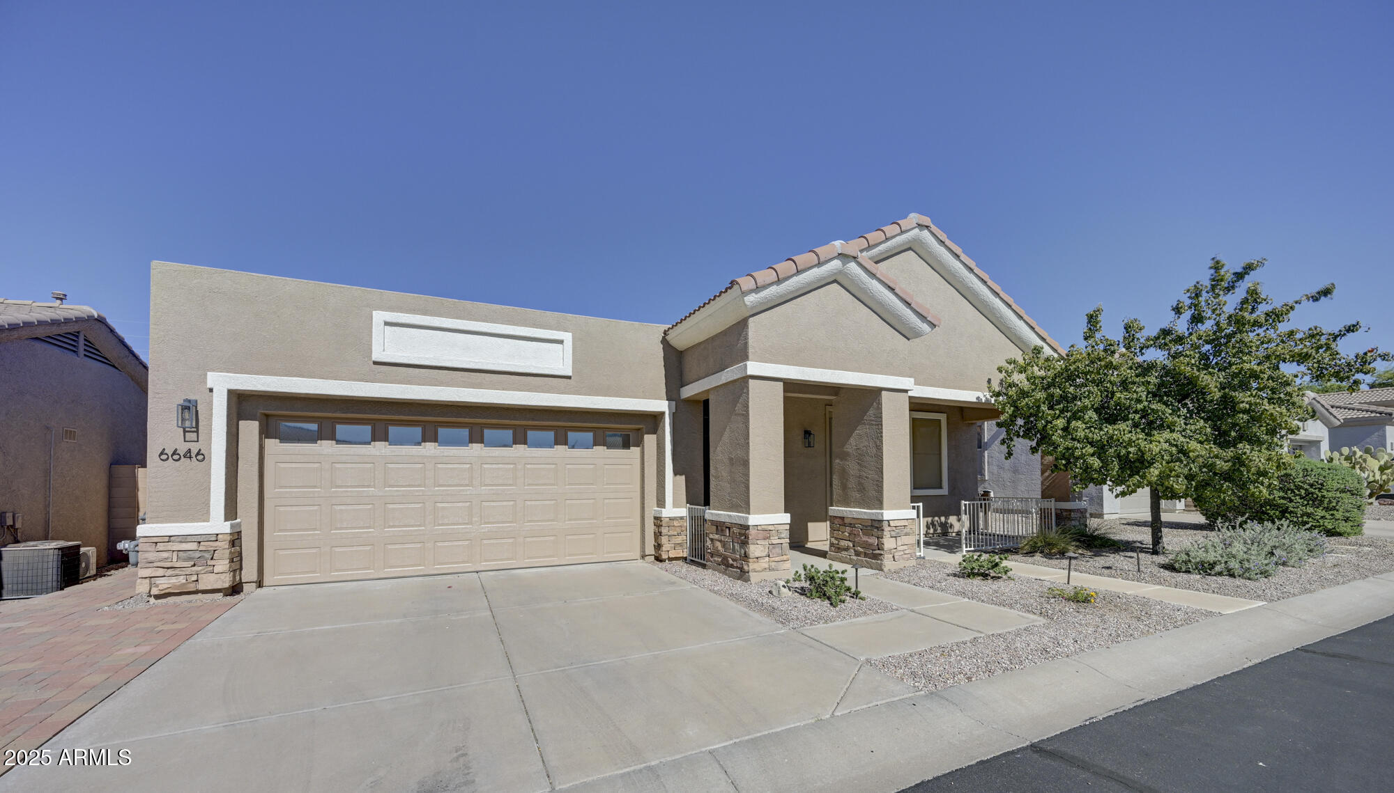 6646 East Rochelle Circle Mesa, AZ 85215 - Photo 2 of 43 a front view of a house with a yard and garage