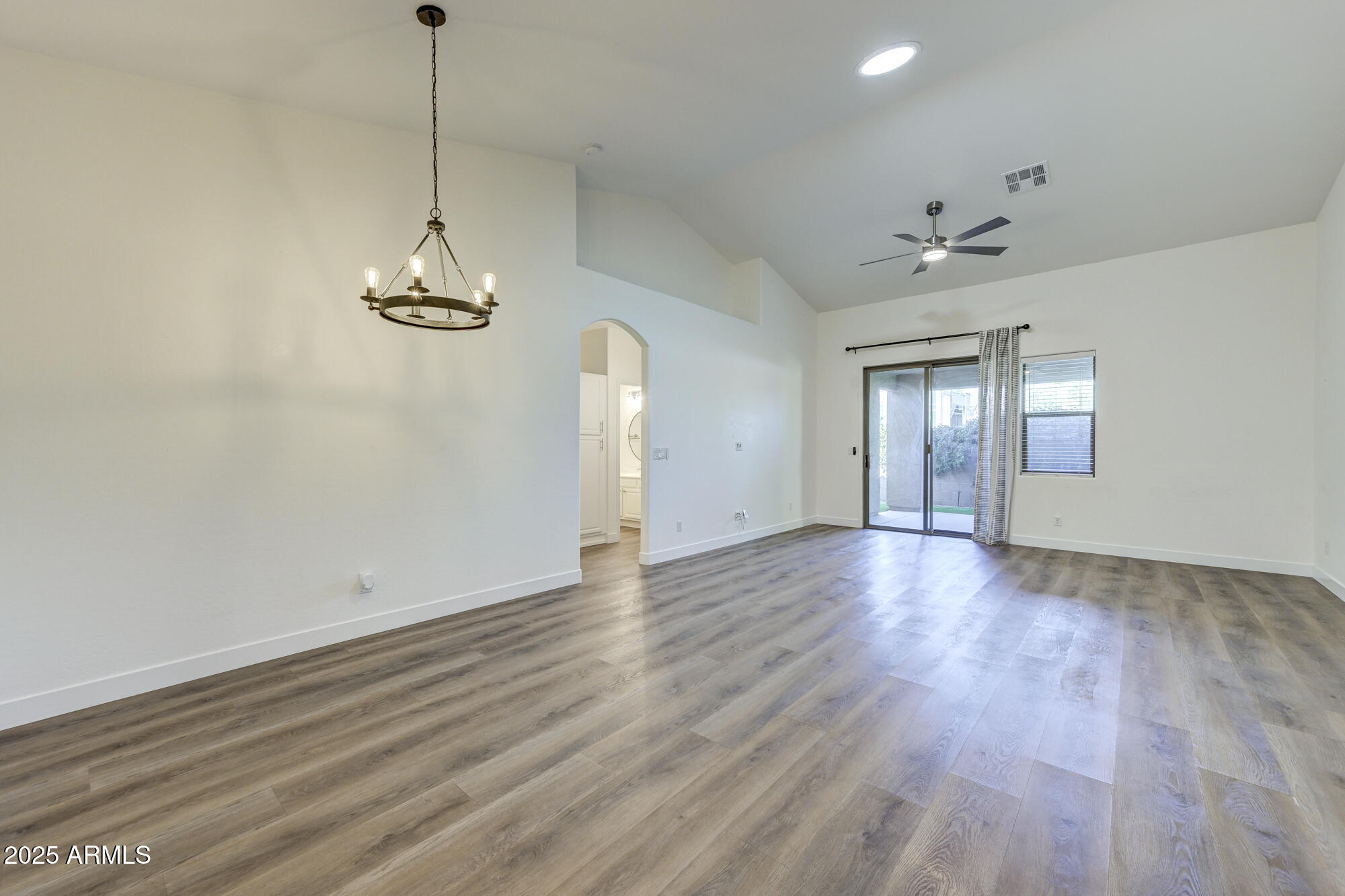 6646 East Rochelle Circle Mesa, AZ 85215 - Photo 6 of 43 a view of empty room with wooden floor and ceiling fan